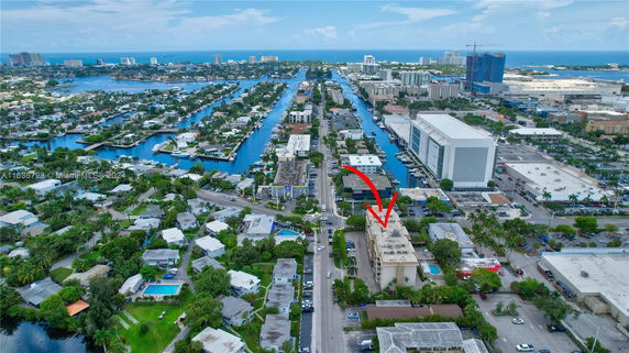 Aerial view of a cityscape with waterways and buildings, highlighting a specific building.