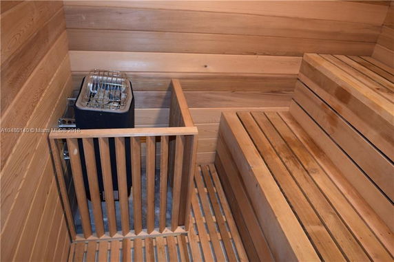 Interior view of a wooden sauna room with a heater.