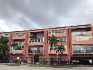 Front view of a multi-story apartment building with balconies.
