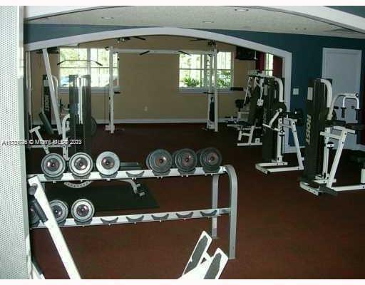 Indoor gym area with various exercise equipment and weights.