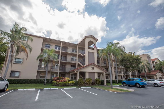 Front view of a multi-story apartment building with balconies.