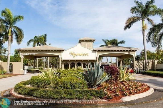 Front view of a building with a covered entrance and landscaped surroundings.