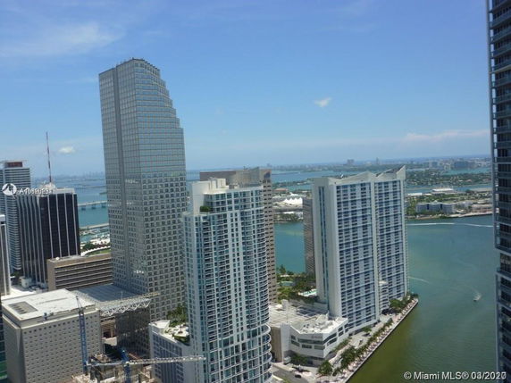 View of tall buildings with water and cityscape in the background.