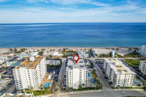 Panoramic view of buildings near a beach with ocean in the background.