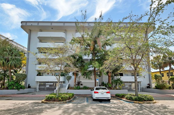 Front view of a multi-story building with balconies.