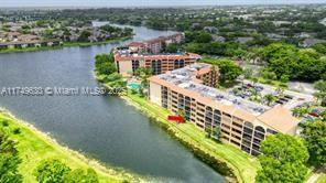 Aerial view of apartment buildings adjacent to a body of water.