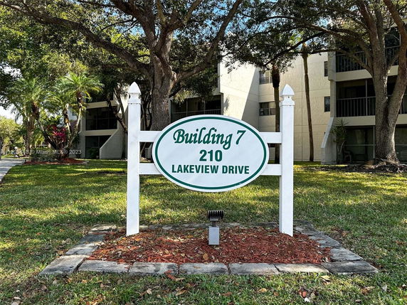 Front view of a multi-story residential building with a sign indicating Building 7 at 210 Lakeview Drive.