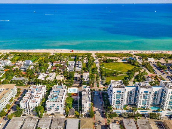 Aerial view of a coastal area with buildings near the beach.