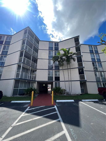 Front view of a multi-story residential building with balconies.