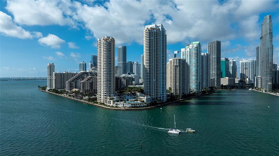 Panoramic view of tall buildings by the waterfront.