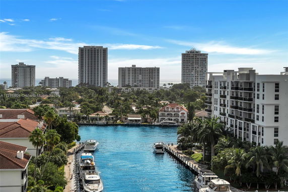 Panoramic view of high-rise buildings and waterways with boats.