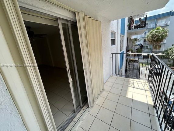 Balcony view of an apartment with sliding glass doors and railing.