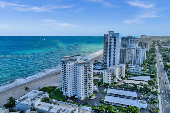 Aerial view of coastal high-rise buildings along a beach.