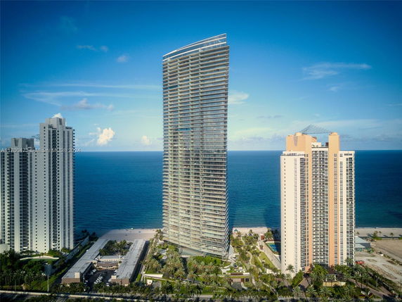 Elevated view of a three high-rise residential buildings near the ocean.