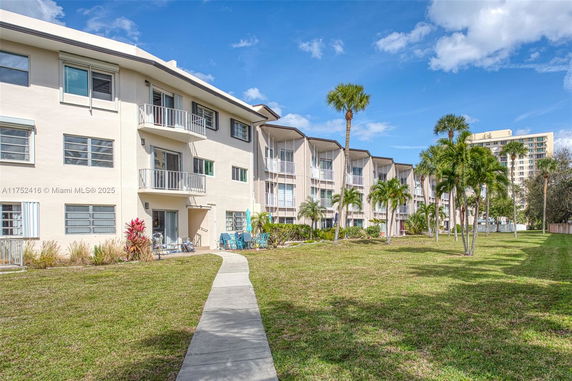 Front view of a multi-story residential building with balconies.
