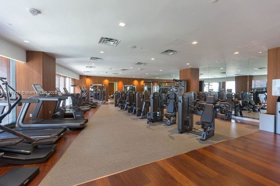 Interior view of a modern gym with various exercise machines and equipment.