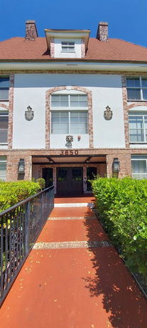 Front view of a building with decorative elements and a walkway.