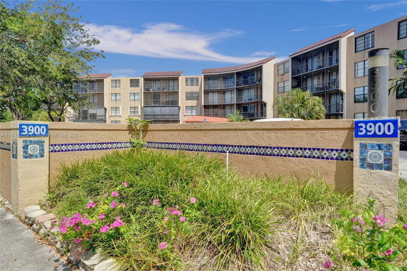 Front view of a multi-story residential building with balconies.