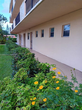 Front view of a multi-story building with balconies.