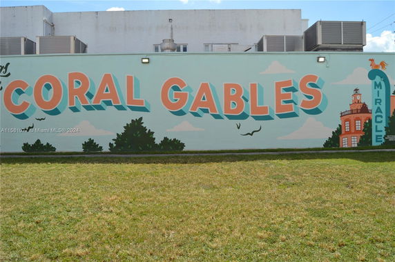 Front view of a building with a colorful mural saying 'Coral Gables'.