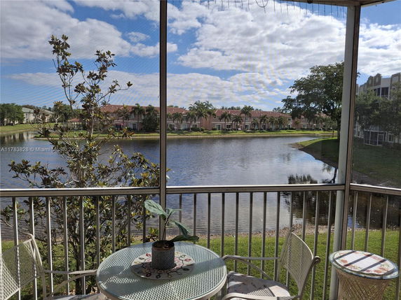 Panoramic view from a building showing a lake with residential buildings in the background.