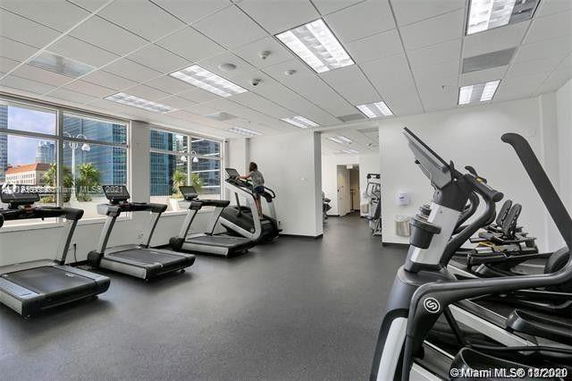 Indoor gym area with multiple treadmills and exercise equipment.