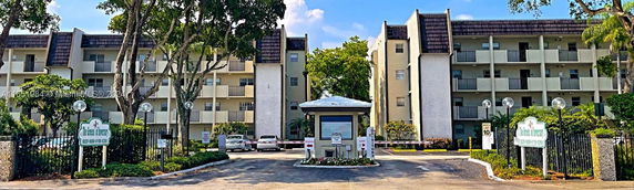 Front view of a multi-story residential building with balconies.