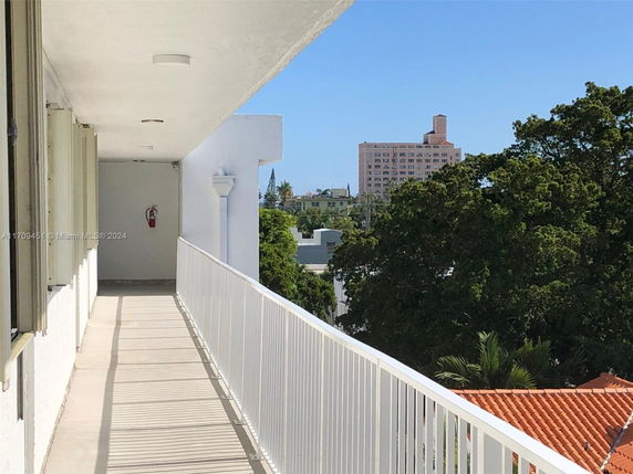 Elevated walkway with view of surrounding buildings and trees.