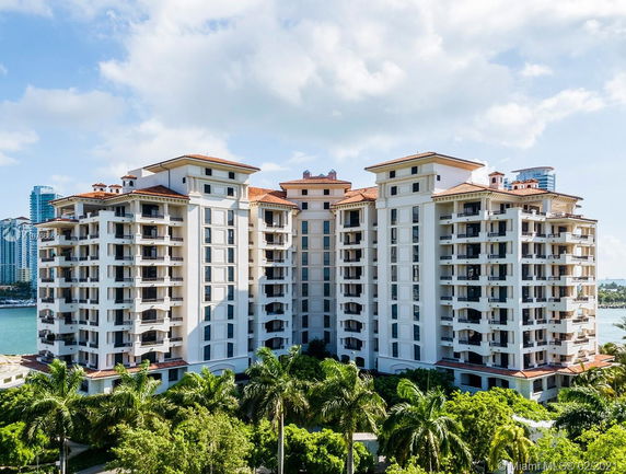 Front view of a multi-story apartment building with balconies.