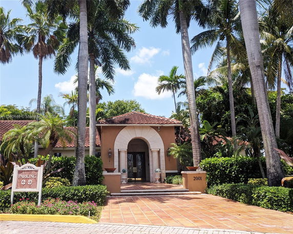 Front view of a single-story house with a tiled roof and archway entrance.