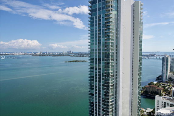 Panoramic view of a high-rise building next to a body of water.