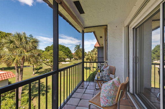 Balcony view with outdoor seating and scenic surroundings.
