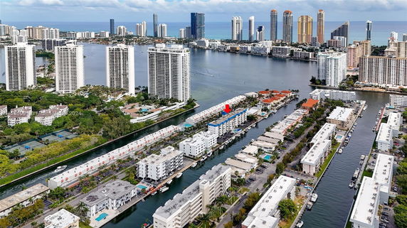 Aerial view of a cityscape with high-rise buildings and waterways.