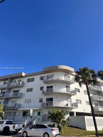 Front view of a multi-story residential building with balconies.