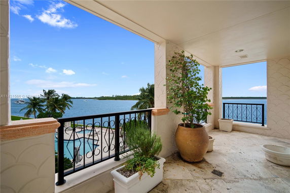 Balcony with a view of the water and surrounding landscape.