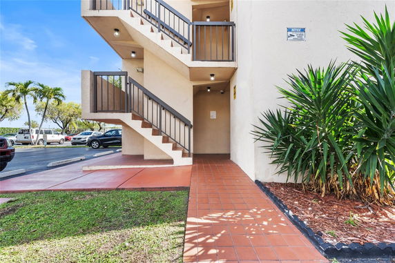 View showcasing an outdoor staircase adjacent to a parking lot area.