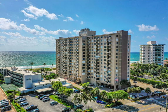 View of tall apartment buildings near the ocean.