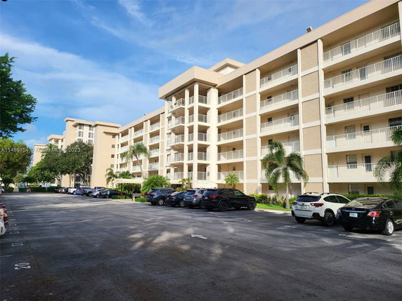 Front view of a mid-rise residential building with balconies.