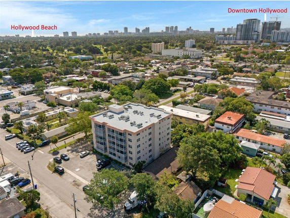 Aerial view of a residential neighborhood with a mid-rise building in the center.