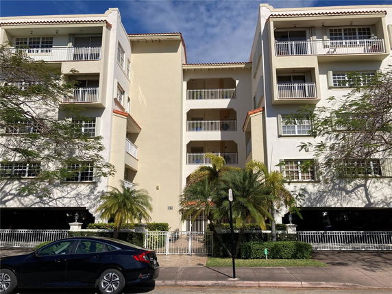 Front view of a multi-story residential building with balconies.