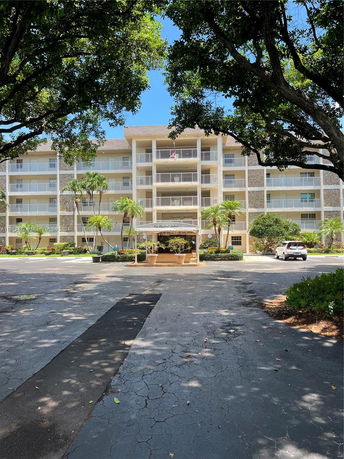 Front view of a multi-story residential building with balconies.