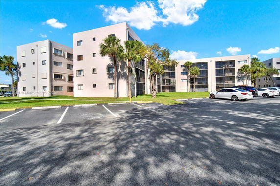 Front view of an apartment building with multiple floors and balconies.