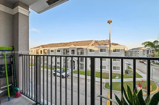 View from a balcony overlooking nearby residential buildings.