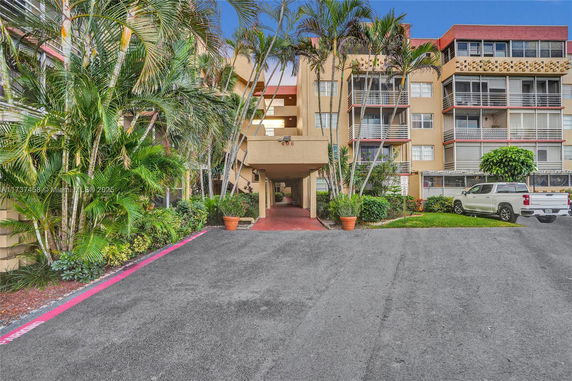 Front view of a multi-story residential building with balconies.