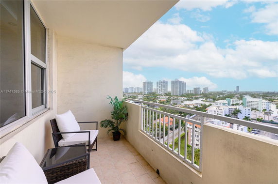 Balcony view of urban area with high-rise buildings in the distance.