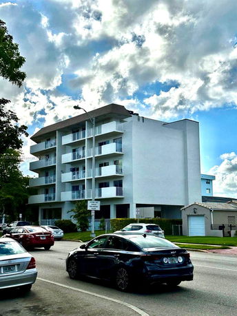 Front view of a multi-story residential building with balconies.