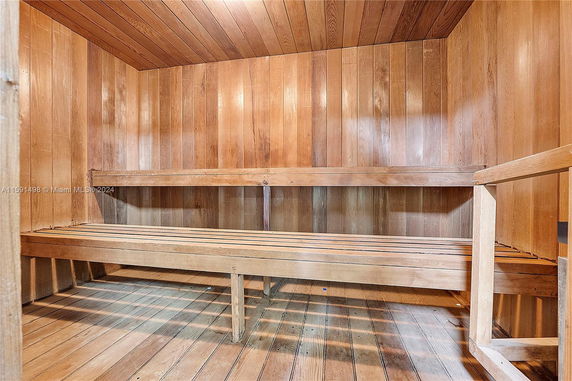 Interior view of a wooden sauna room with benches.