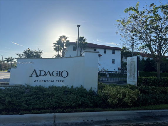 Front view of a residential building with signage 'Adagio at Central Park'.