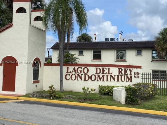 Front view of a condominium building with a sign displaying 'Lago Del Rey Condominium'.