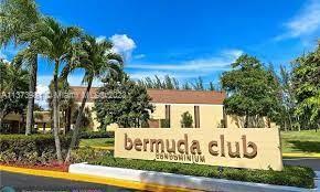 Front view of a condominium building with the name 'Bermuda Club' displayed on a sign.